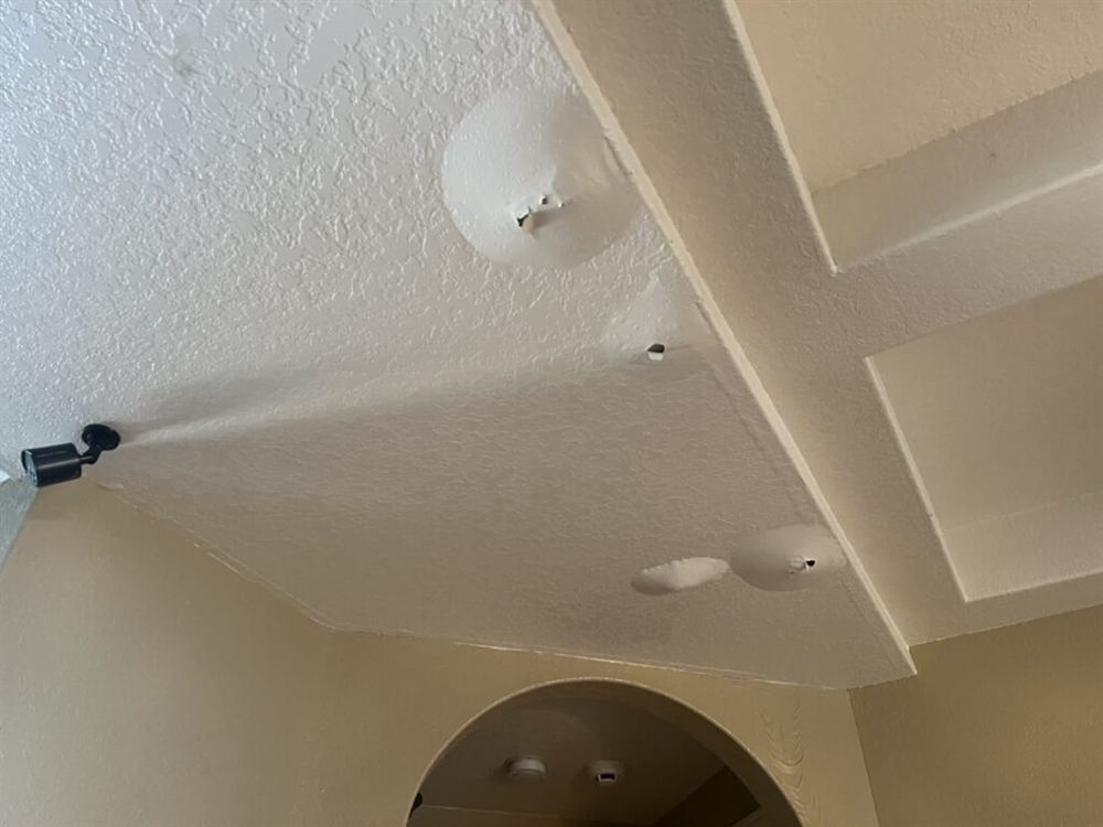 Ceiling showing water damage and staining in a San Antonio home