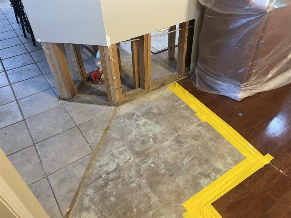 Kitchen demo with containment barrier and exposed studs in New Braunfels