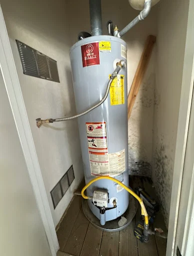 Mold growth behind water heater from slow leak in Schertz